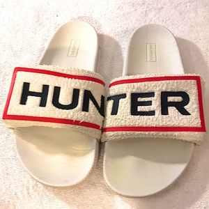Hunter slide flip flops.